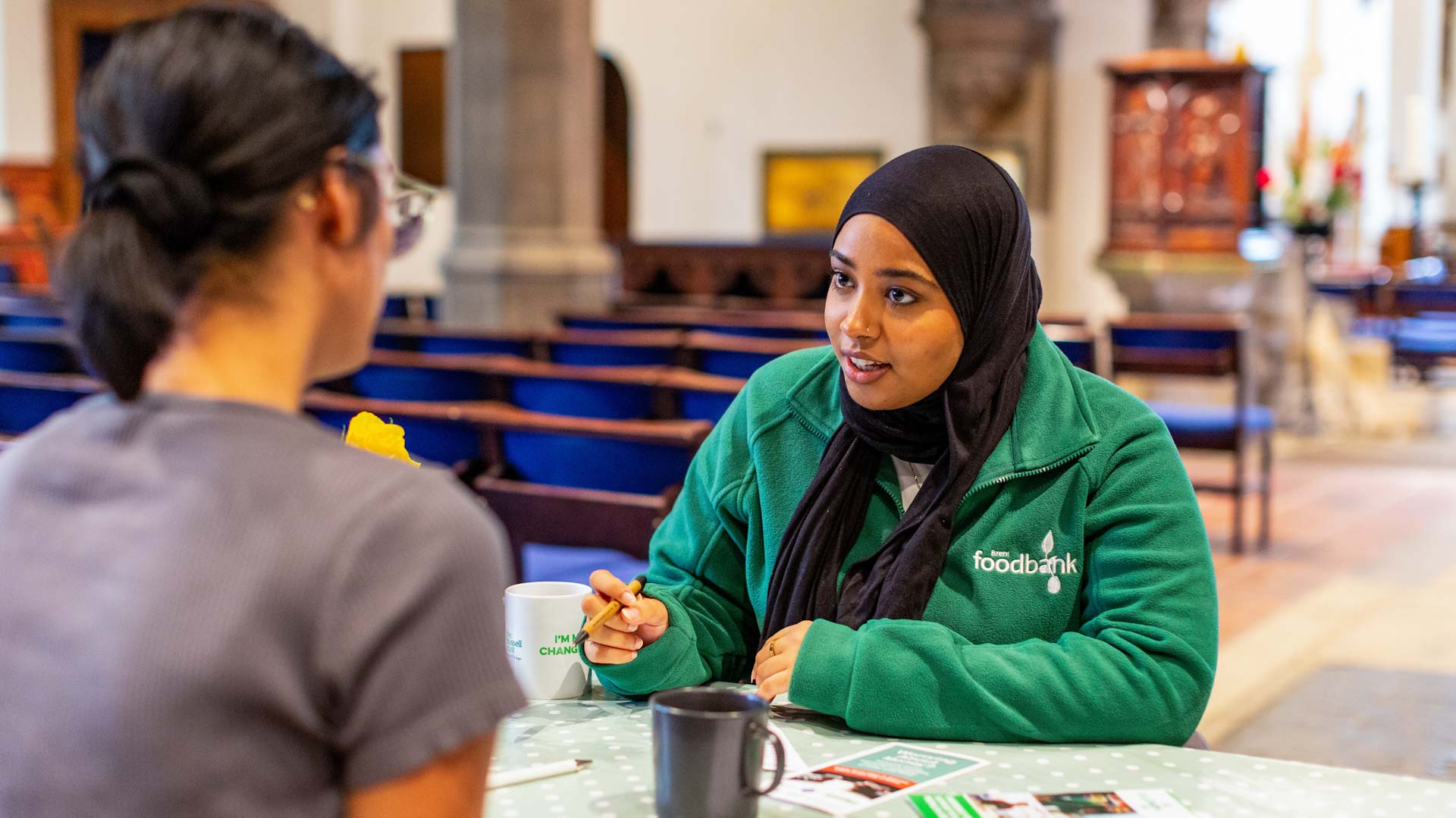 Foodbank volunteer giving advice to client