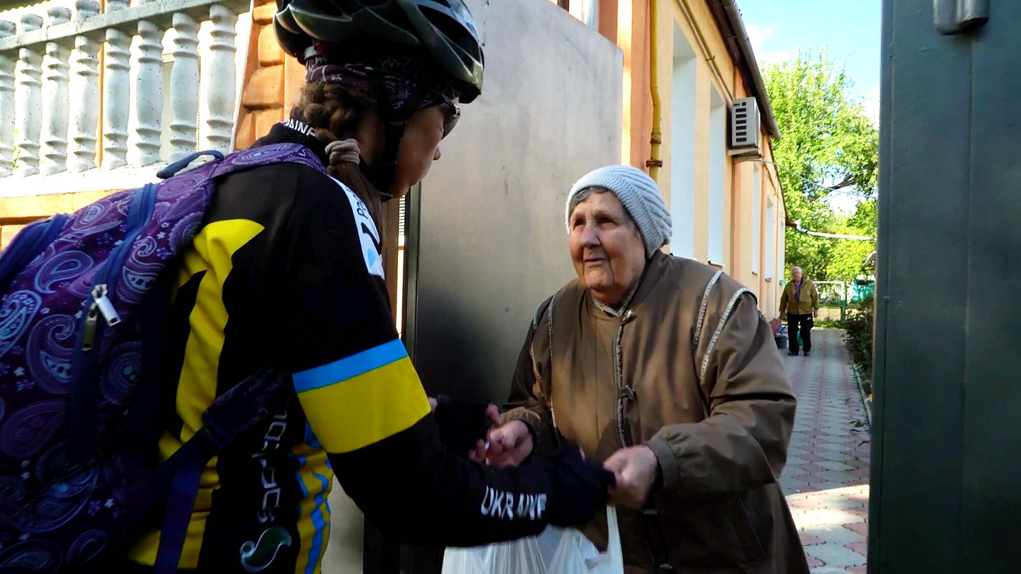 Depaul team member handing over supplies to Ukrainian woman