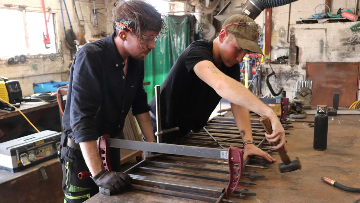 Trainee blacksmiths in a workshop