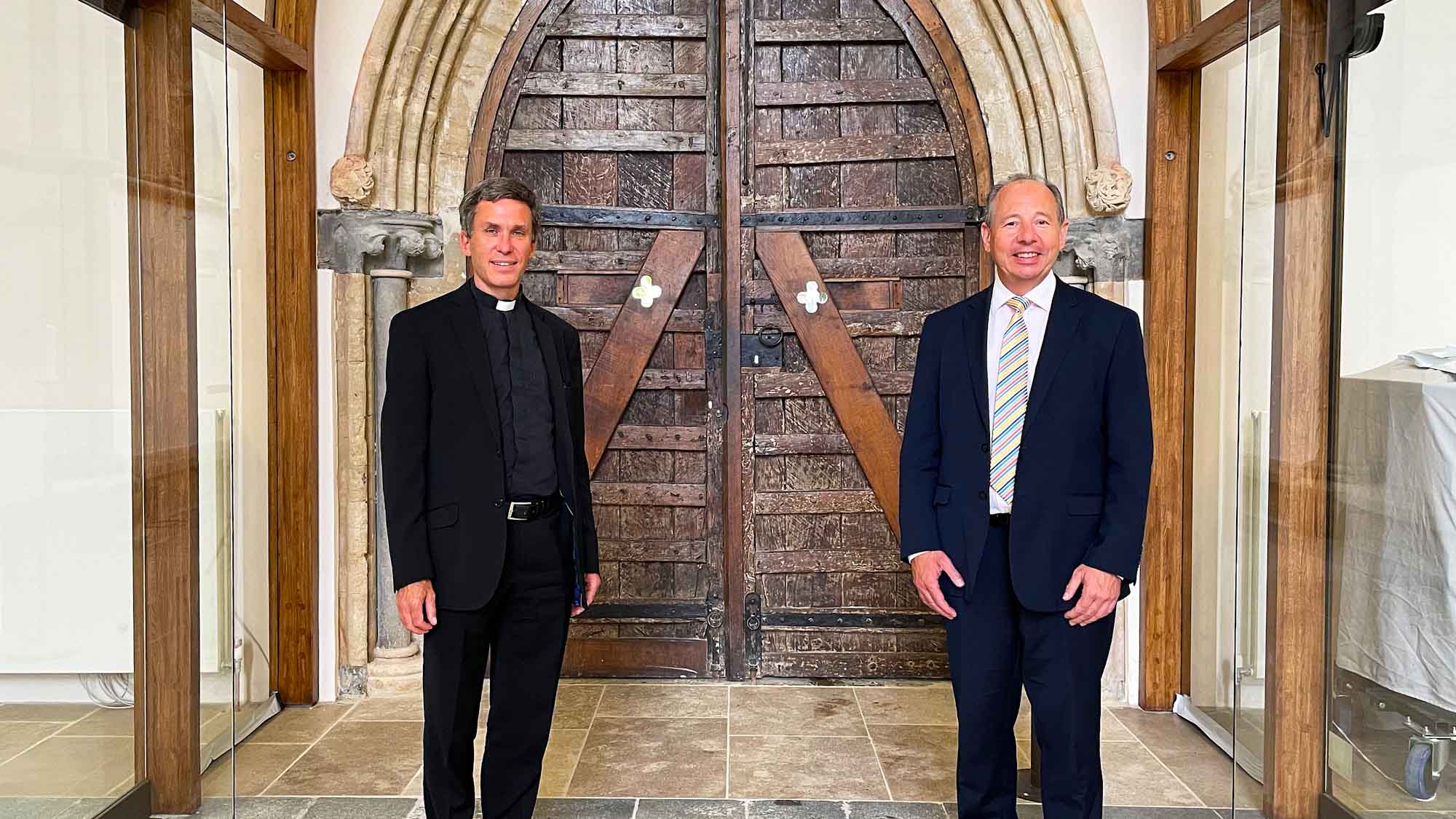 Paul Playford and Canon Chris Palmer standing in front of new glass lobby