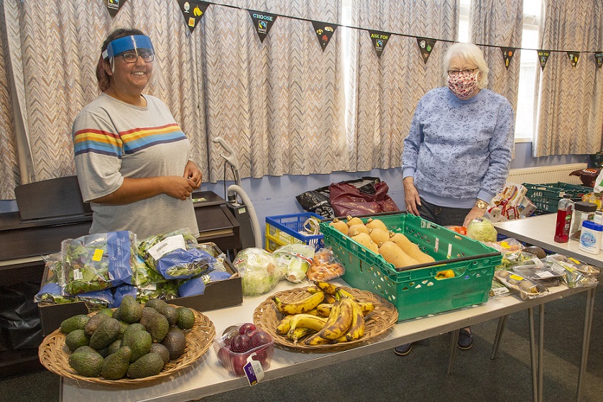 Two women helping with the food support in the church
